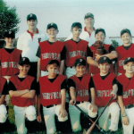 Nicholas Fainlight posing with his little league baseball team